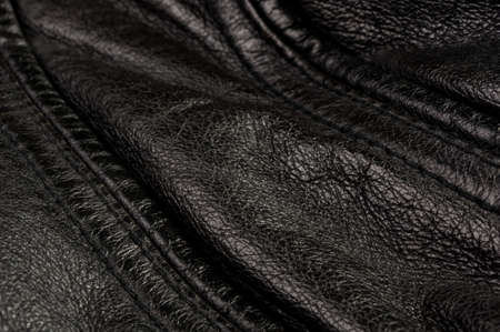 Old vintage genuine soft black leather texture background, top layer with pores and scratches, macro