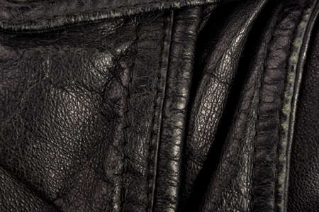 Old vintage genuine soft black leather texture background, top layer with pores and scratches, macroの写真素材