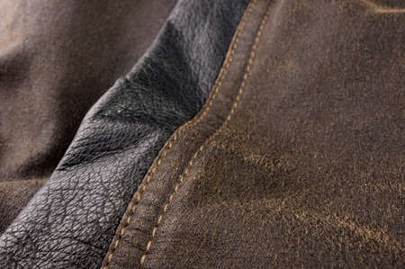 clothing items stonewashed cotton fabric texture with seams, clasps, buttons and rivets, macro