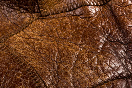 Old vintage genuine soft brown leather texture background, top layer with pores and scratches, macro, close-upの写真素材