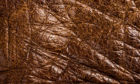 Old vintage genuine soft brown leather texture background, top layer with pores and scratches, macro, close-upの写真素材