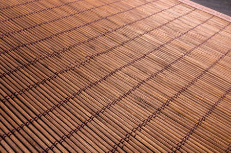 brown bamboo Mat - stand food, close-up, macro, black backgroundの写真素材