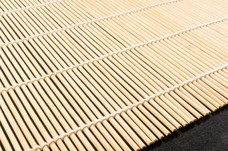 brown bamboo Mat - stand food, close-up, macro, black backgroundの写真素材