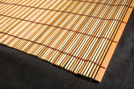 brown bamboo Mat - stand food, close-up, macro, black backgroundの写真素材