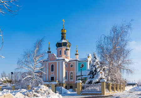 Winter landscape - Orthodox church in the snow among trees on a frosty dayの写真素材