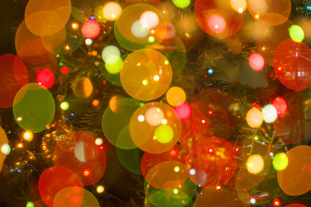 Christmas background-garlands with colorful lights on a decorated Christmas tree, bokeh, close-upの写真素材