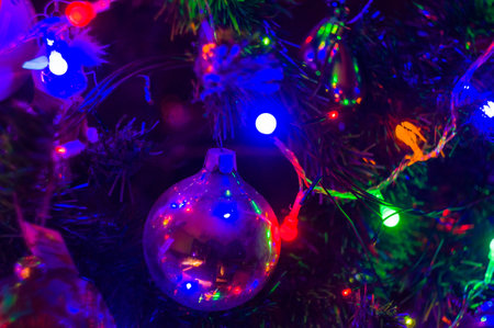 Christmas background-garlands with colorful lights on a decorated Christmas tree, bokeh, close-upの写真素材