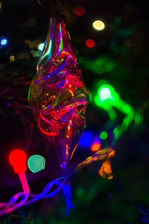 Christmas background-garlands with colorful lights on a decorated Christmas tree, bokeh, close-upの写真素材