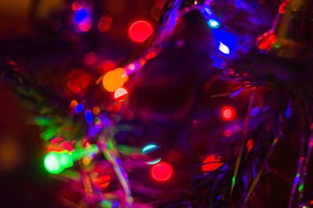 Christmas background-garlands with colorful lights on a decorated Christmas tree, bokeh, close-upの写真素材