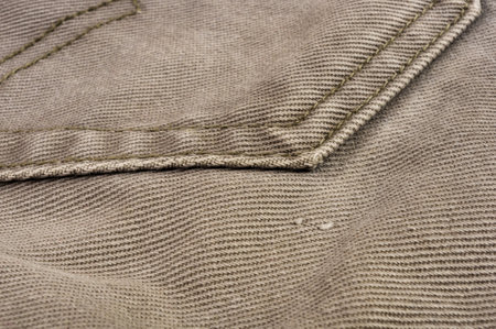 clothing items washed cotton fabric texture with seams, clasps, buttons and rivets, macro, close-upの写真素材