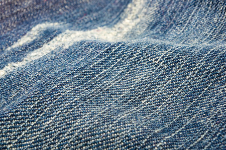 clothing items blue washed faded jeans cotton fabric texture with seams, clasps, buttons and rivets, macroの写真素材