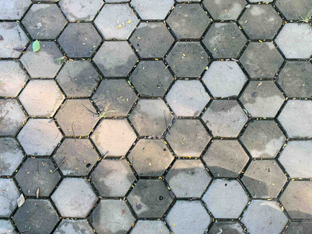 Hexagon-patterned concrete floor with sunlight shining from the middle to the edge of the picture