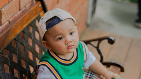 A cute boy wearing a fashion photoshoot looks fresh and posing looking at the cameraの写真素材