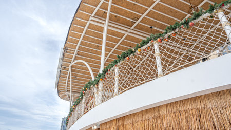 Buildings used for recreation Decorate the fence with white netting and Christmas pine. Light brown thatched walls Focus on nature See a bird's-eye view. Can be used as a backgrounの写真素材