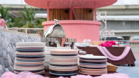 Picture of a table with equipment in a restaurant On the table were three colorful plates stacked alternating with each other. The plates were round and flat. Placed in different hの写真素材