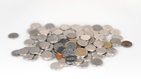 pile of coins that have a mixed value with the currency being baht Close-up focus on coins and...