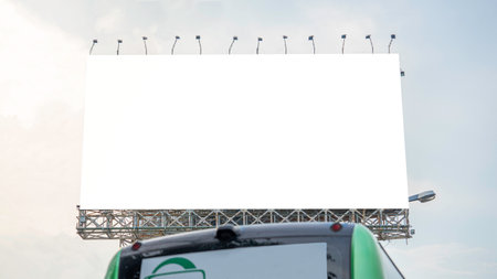 A large advertising billboard is located outdoors with a background of a light-colored sky. Similar to the morning atmosphere when the sun is rising. Suitable for use in creating aの写真素材