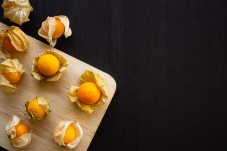 Cape gooseberry or physalis minima on wood background. Tropical fruit and food for health concept.の写真素材