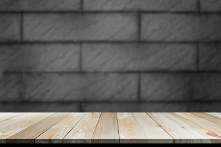 Empty room interior wood table gray dark brick floor with copy space for add text presentation.wooden floor perspective. can montage display or deiting put product on wood and text on background.の写真素材