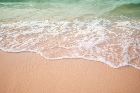 Sand beach with white sea soft wave on top view for assembling an article about travel in summer holiday or ocean coast nature.の写真素材