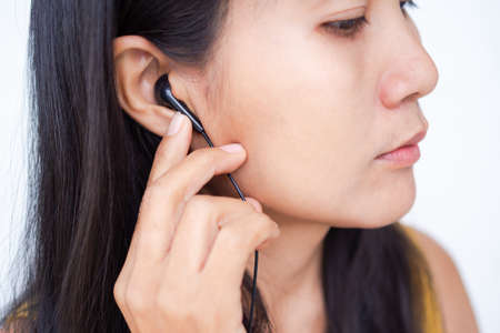 Asian woman with headphones  close up. business and technology concept.の写真素材