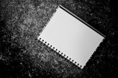 Broken heart concept. blank book on black dard floor cement. top view with copy space.の写真素材
