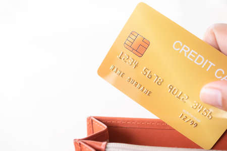Finger holding credit card in wallet with white background. pay loan buy shopping with electronic...