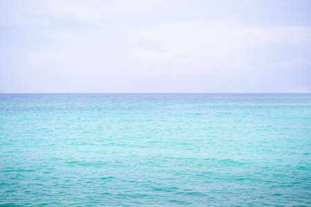 Blue Sea with White Cloud Sky Day Light Horizon view Background. Texture Surface Still Calm Peaceful of Water Ocean. Clean Clear Landscape. Tropical Travel Summer Holidays, Environmentの写真素材