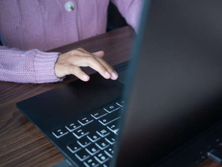 Woman with sweater Touch Screen on Touch Pad laptop Keyboard Notebook Computer.staff working job in office, shopping online on communication internet. Technology for business and lifestyles concept.の写真素材