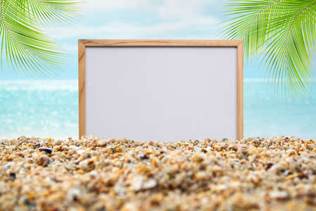 Mockup on sea with leaves palm at coast. blank board on sand beach and blue oceand seaside and blue sky. white board free space wite coconut for Tropical tourism relax vacation travel summer holidays.の写真素材