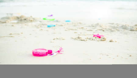 Toy on sand beach background at coast. bauble of child in holidays with family. tourist travel tropical sea summer concept.の写真素材
