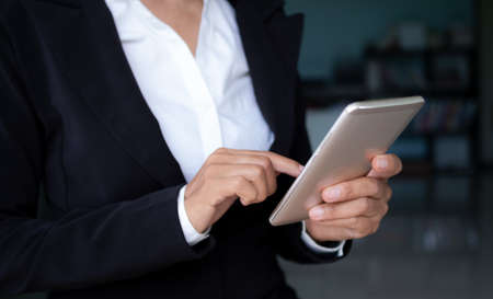 Senior woman use touchscreen mobile. she working in office. communication wireless internet hi speed.staff woman professional. technology for business or finance concept.の写真素材