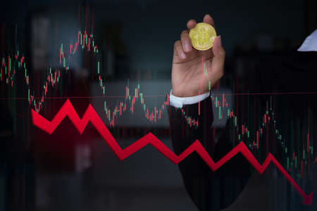 Hand woman with Bitcoin Crypto Currency growth in Stock Market Down trend line graph.Block Chain...
