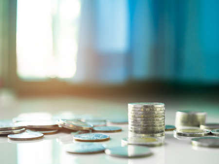 Stack coin on wooden background. pile thai cash and blur floor bank account. plan investment income for 2023 new year. business or finance concept.の写真素材