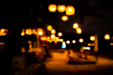 Light night bokeh dark black background. Abstract golden circle effect sparkle blurry backdrop. for invitation special gala,birthday,christmas holidays celebration. happy new year 2023 concept.の写真素材