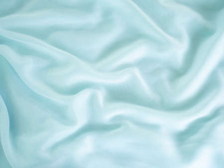 Blue fabric linen background.texture wave surface cotton fashion backdrop. luxury display silk cloth free space for add text or products presentation. soft smooth satin wallpaper pattern design.の写真素材