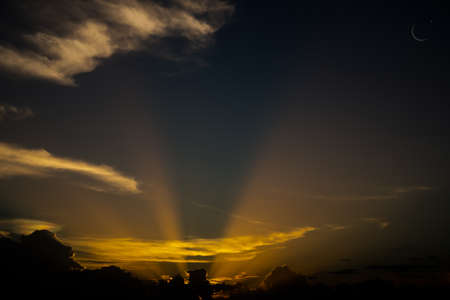 Ramadan, Eid ai-fitr,New year Muharram islamic religion Symbols with Crescent Moon and star silhouette on dark gold and dark black twilight sky in night sunset. copy space for add text presentation.の写真素材