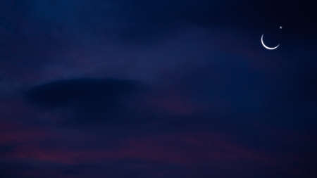 Ramadan, Eid ai-fitr,New year Muharram islamic religion Symbols with Crescent Moon and star silhouette on dark blue and dark black twilight sky in night sunset. copy space for add text presentation.の写真素材