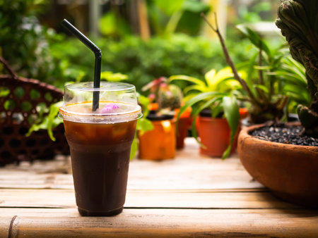 Ice Americano Black Coffee in Glass on Wooden Table,Fresh Drink for Summer Tropical,Cold Tea Drink and Sweet Have caffeine in Cafe Shop in Restaurant,Snack Food concept.の写真素材