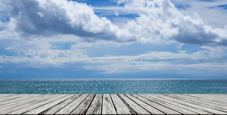 Empty Wooden Table on Sea Summer Background,Blank desk with Blur Ocean,water ocean Blue Sea,blue sky Horizon Landscape Outdoor photo backdrop,Mockup Board for Presentation,Tropical Nature Tourism.の写真素材