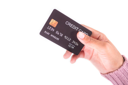 Hand Woman with Sweater holding Credit Card on white background, Technology Electronic for Pay of Buy Products Shopping,Plan Investment Income and Save Money for 2023 Wew Year,Business or Finance.の写真素材