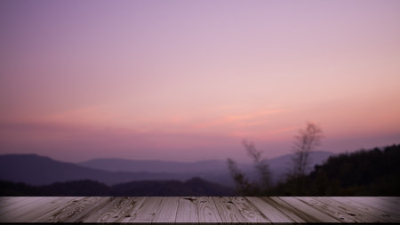 Empty Wooden Table counter on Sunset Nature with Forest and Mountain Background,Mock up with Display Sunrise landscape evening Sunlight Backdrop,Autumn Season Outdoor Design,Silhouette growth Tree.の写真素材
