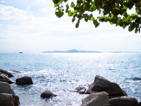 Stone on Blue Sea and Blue Sky Background,Ocean Island Clouds Horizon Nature Landscape,Calm water in Morning,à¸ºBrine at Coast,Tourism Tropical travel in Holidays concept.の写真素材