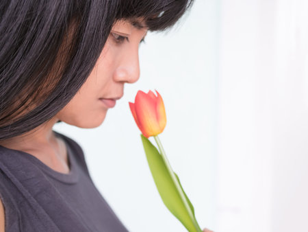 Woman Smelling Tulips Flowers Close Upの写真素材