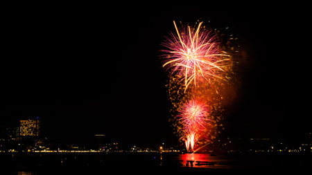 Firework on Black Dark Sky Background,Celebrate Party Merry Christmas and Happy New Year Festival,Light Bright Bokeh Gold Abstract Burst Fire Anniversary Birthday Holidays Wallpaper,Colorful Night.の写真素材