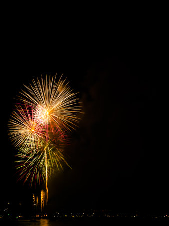 Firework on Black Dark Sky Background,Celebrate Party Merry Christmas and Happy New Year Festival,Light Bright Bokeh Gold Abstract Burst Fire Anniversary Birthday Holidays Wallpaper,Colorful Night.の写真素材