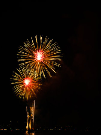 Firework on Black Dark Sky Background,Celebrate Party Merry Christmas and Happy New Year Festival,Light Bright Bokeh Gold Abstract Burst Fire Anniversary Birthday Holidays Wallpaper,Colorful Night.の写真素材