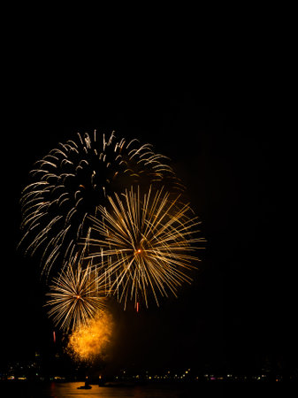 Firework on Black Dark Sky Background,Celebrate Party Merry Christmas and Happy New Year Festival,Light Bright Bokeh Gold Abstract Burst Fire Anniversary Birthday Holidays Wallpaper,Colorful Night.の写真素材