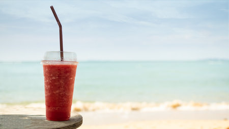 Watermelon Red Smoothie in Glass on Blur Blue Sea and Blue Sky Background,Summer Drink Beverage Sweet Cocktail Snack Tropical,Food for Diet Herb Natural Healthy Juice Fruits Beverage Vegetarian.の写真素材