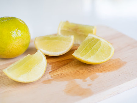 Lemon Slice on wooden cutting board with white background,Yellow Lime Citron Raw Food Orgarnic Nature Tropical Fruits,Cooking Juice Drink in Kitchen,Vegetarian Hight Vitamin C for Diet Health.の写真素材